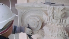 Banker carving stone capital